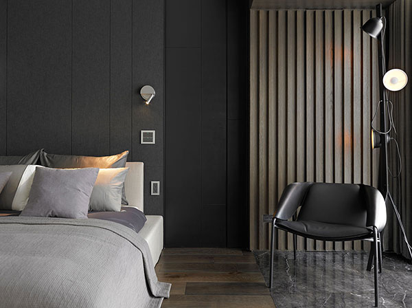 侧卧黑色背景墙和灰色床品展现出空间的简约时尚，灯光照明增加了空间的律动感，使空间显得更加具有层次。
