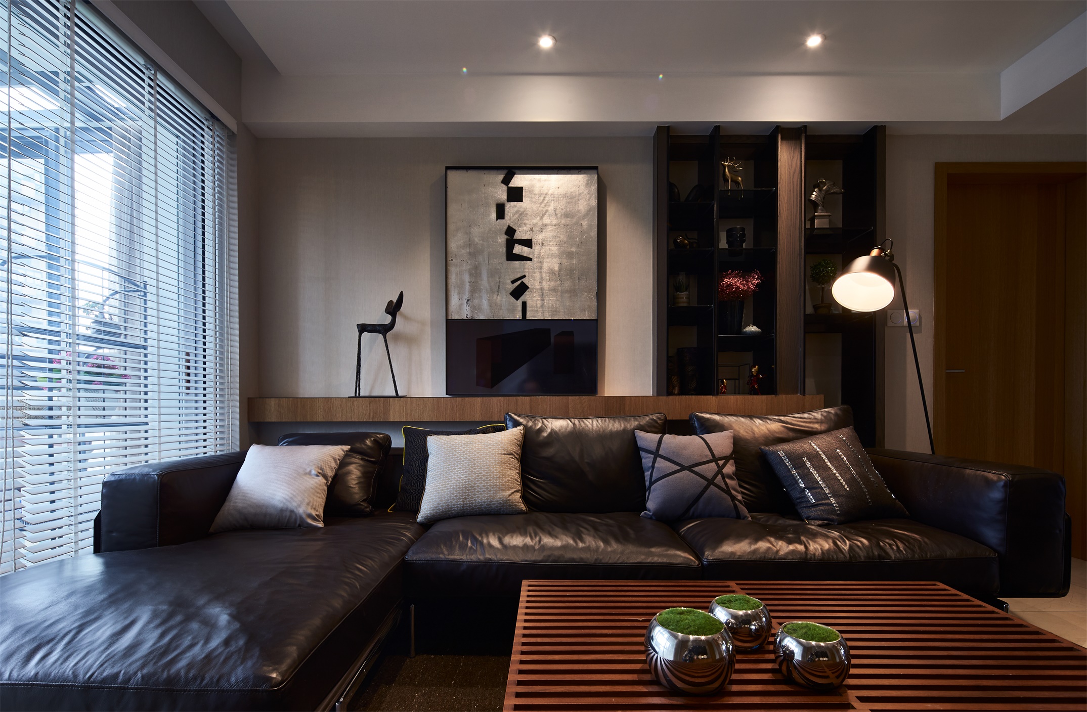 客厅布局遵循现代风格设计逻辑，深色调渲染呈现出理性、静谧居家氛围。