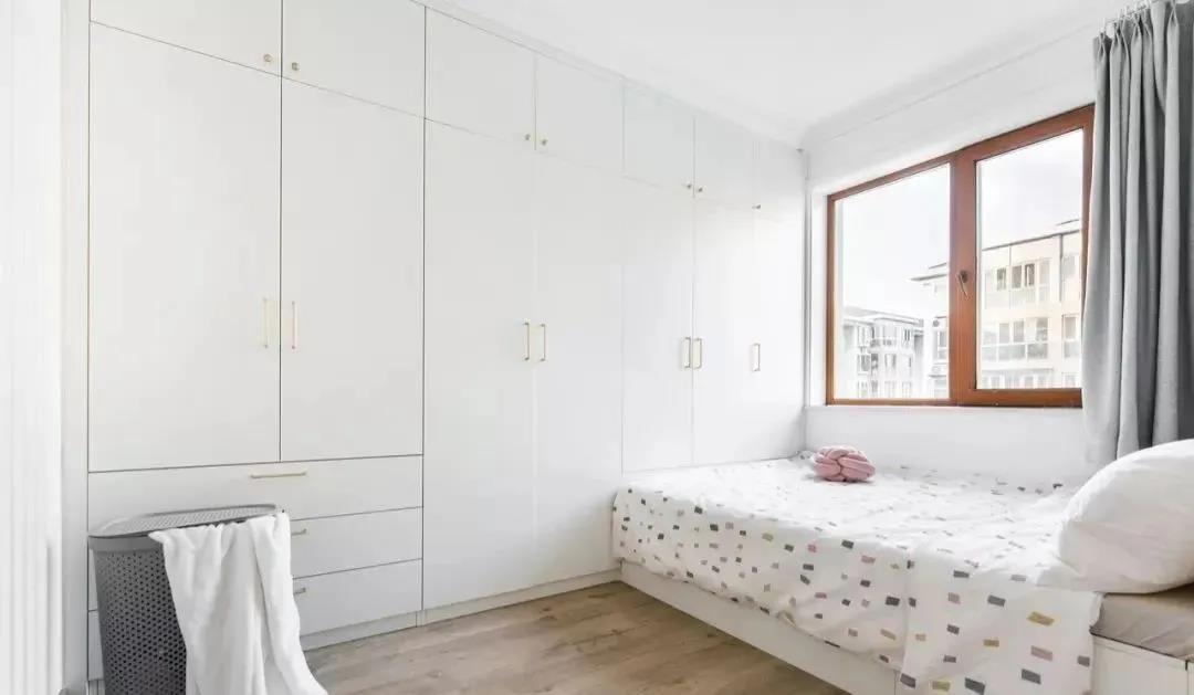 侧卧使用面墙打造衣柜,配合淡雅的白色调,来减轻满面柜子的沉重感.