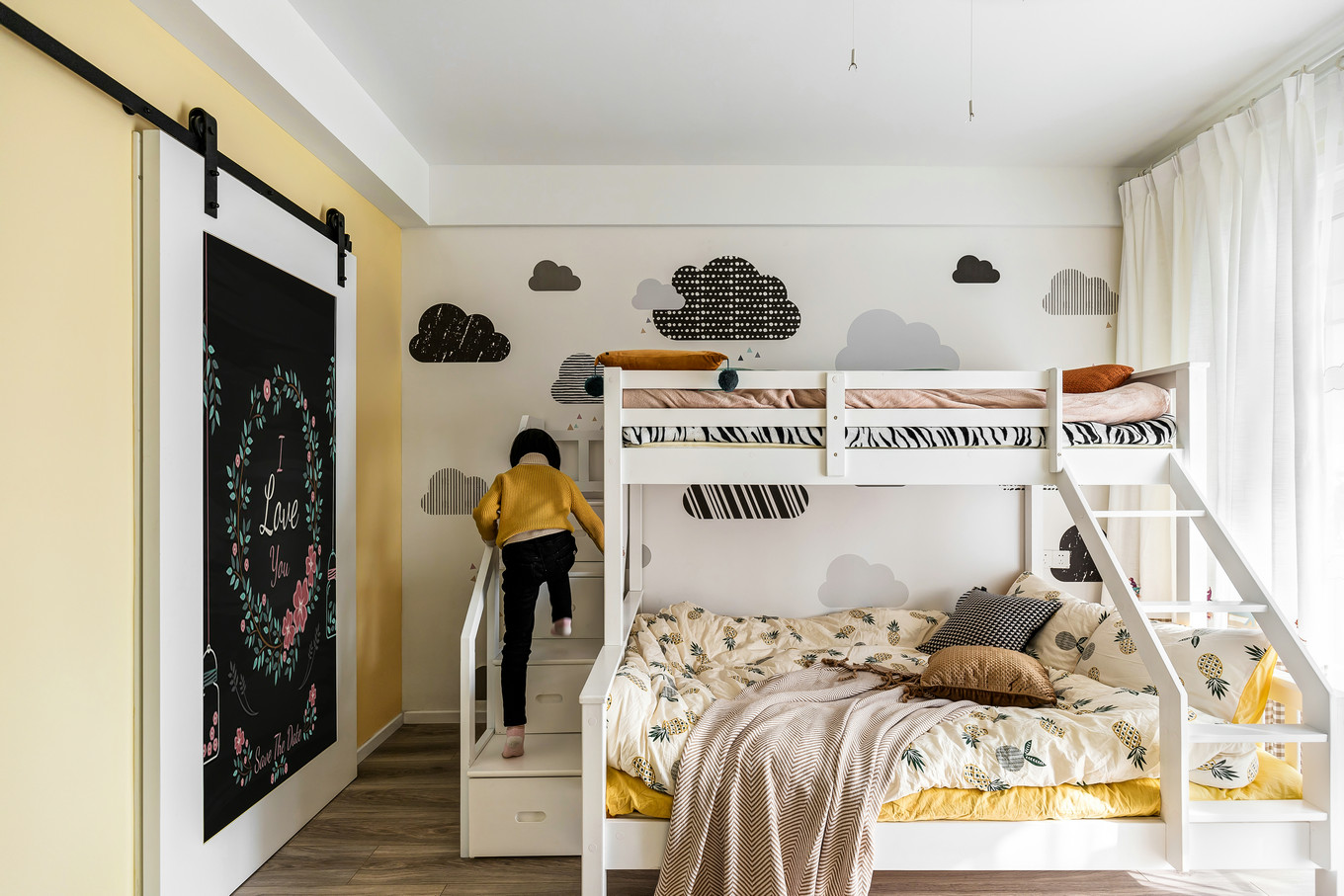 儿童房卡通元素较多，白色高低床简约不简单，搭配童趣壁纸与床品，充满了温馨感。