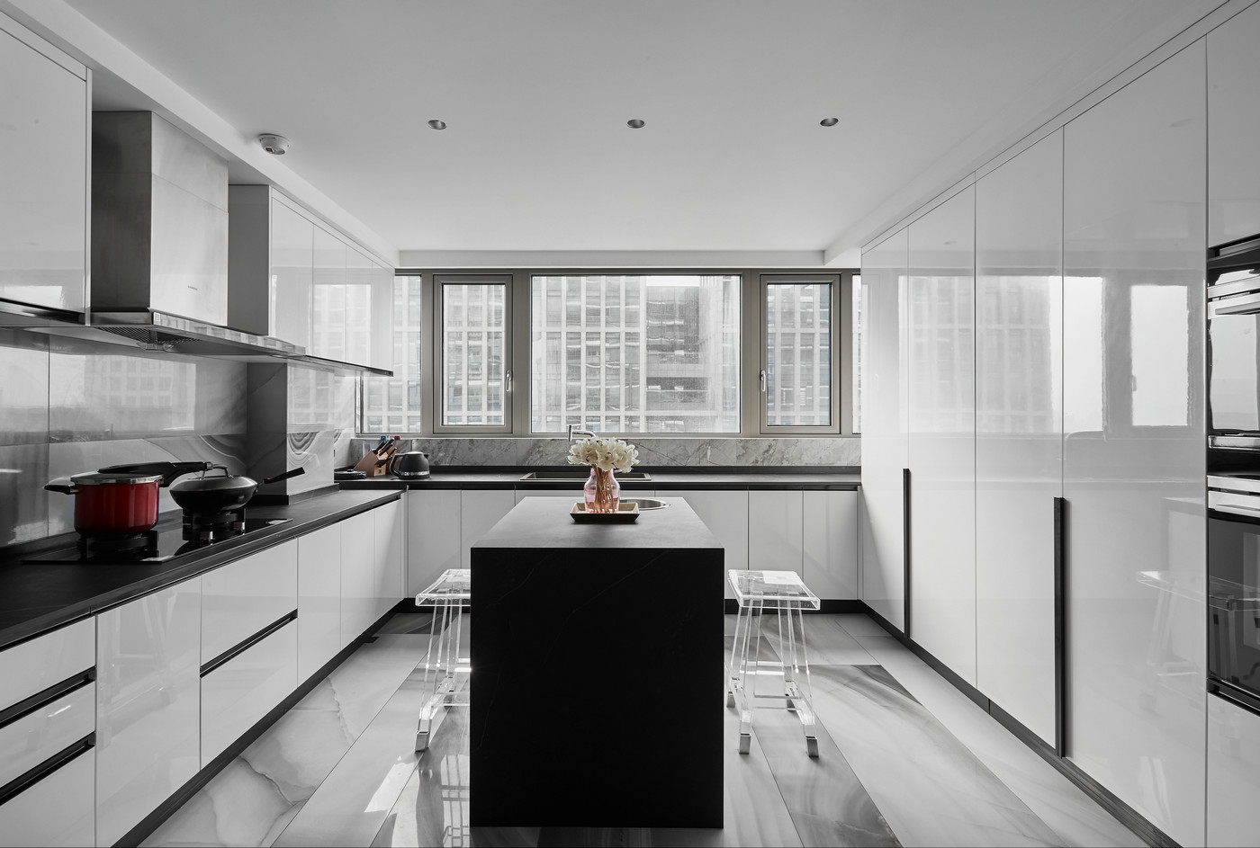 厨房以白色为基调，局部黑色岛柜化解了空间的乏味，优化了空间动线。