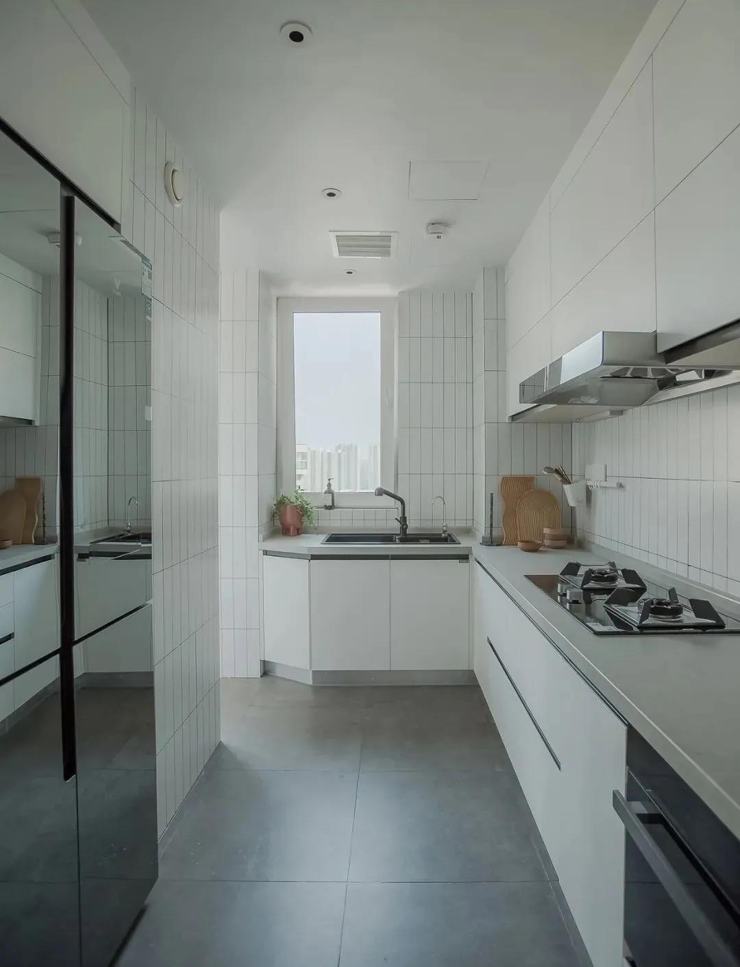 厨房以白色为基调，彰显出精致的生活态度，L型橱柜设计动线高效，视觉效果非常静谧。 