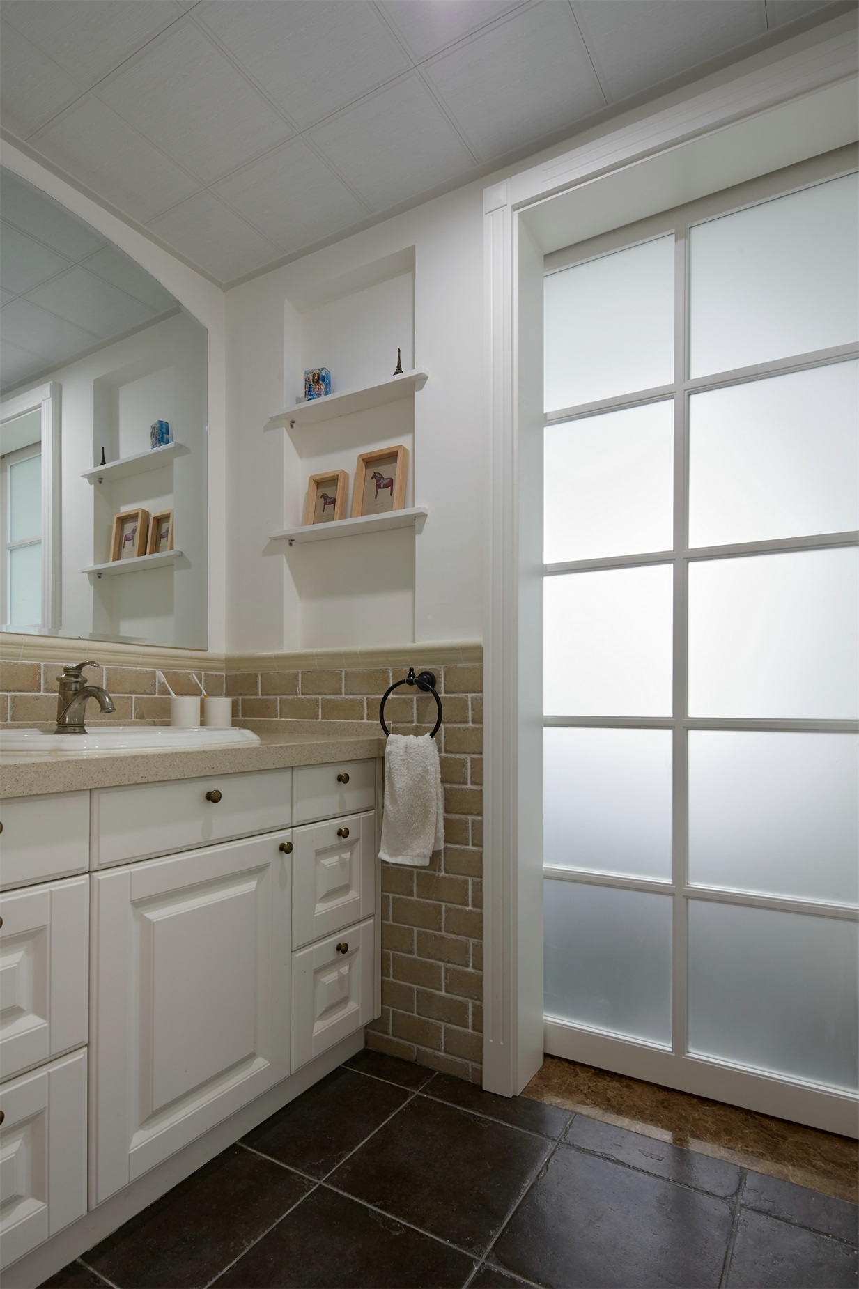 卫生间洗手池外移设计，背景墙腰线处以米色瓷砖铺贴，制造了些许温馨感。