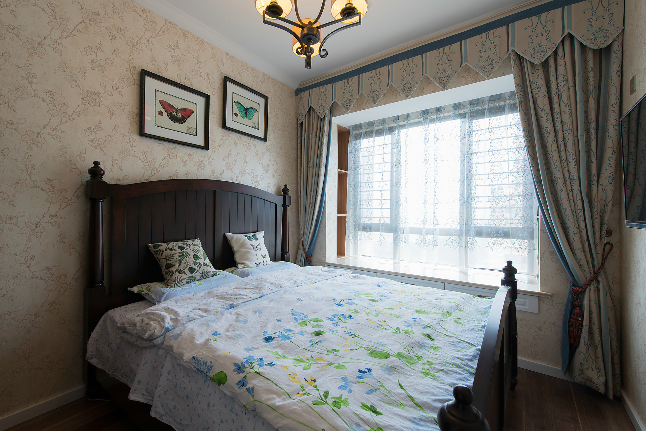 次卧沿用碎花式壁纸，配以木质双人床，给予业主安适惬意的生活体验。