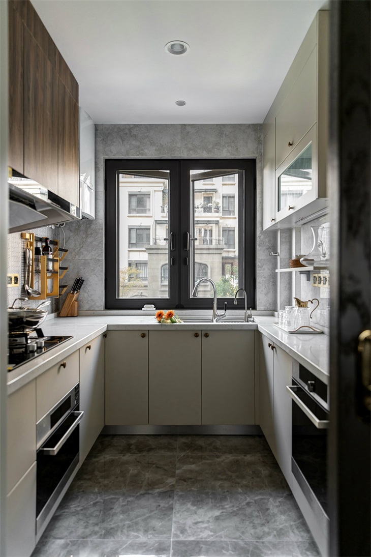 U型厨房结构紧凑，动线设计合理，米色橱柜和咖色吊柜设计，凸显自然。