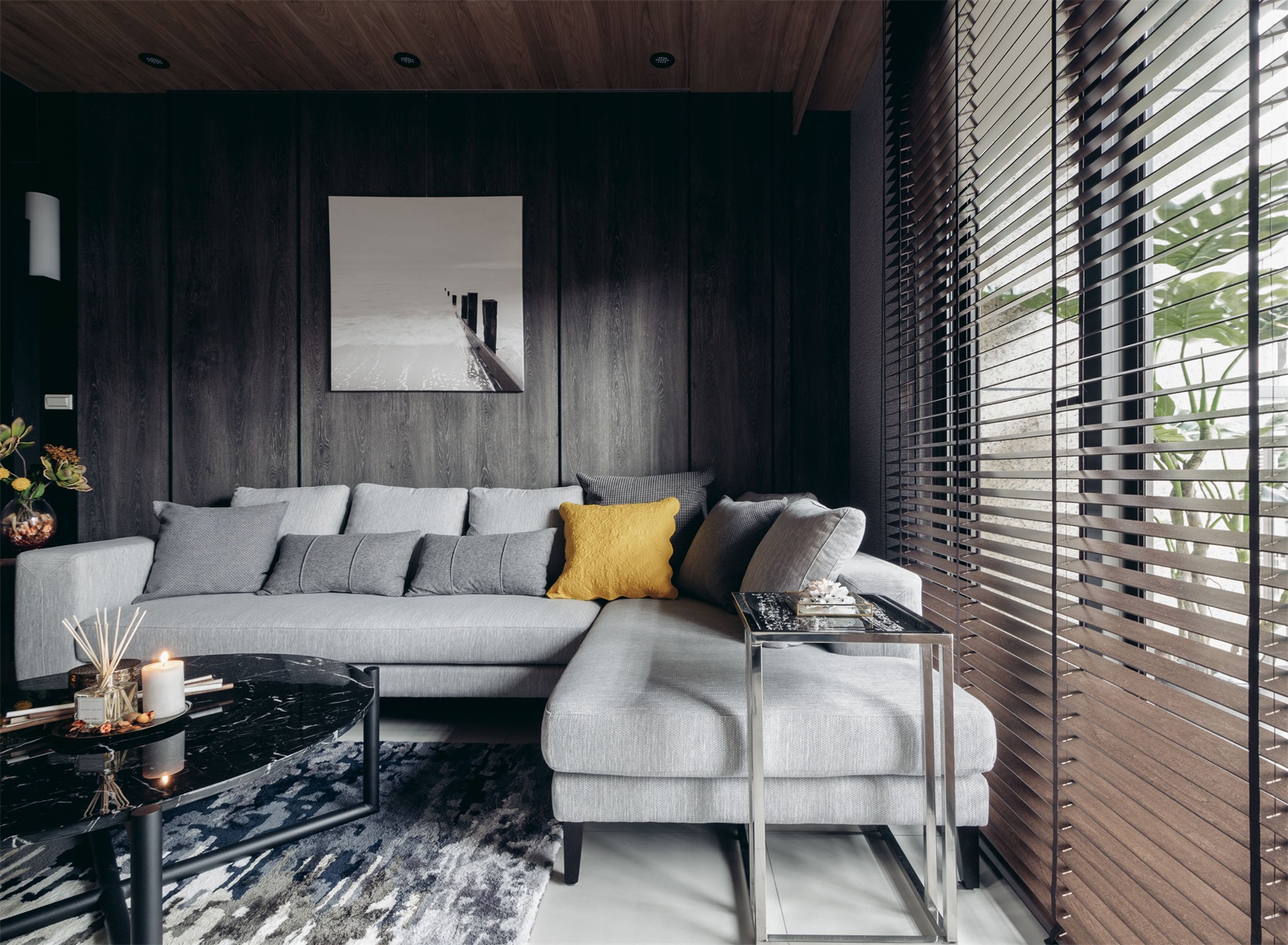 客厅以木质调为主色，干净利索，灰色布艺沙发和白色装饰画形成了对比。