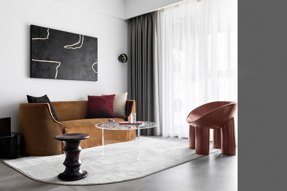客厅使用了大白墙，空间中带着些许温柔的既视感，暖色基调的软装弥漫着温馨的氛围。