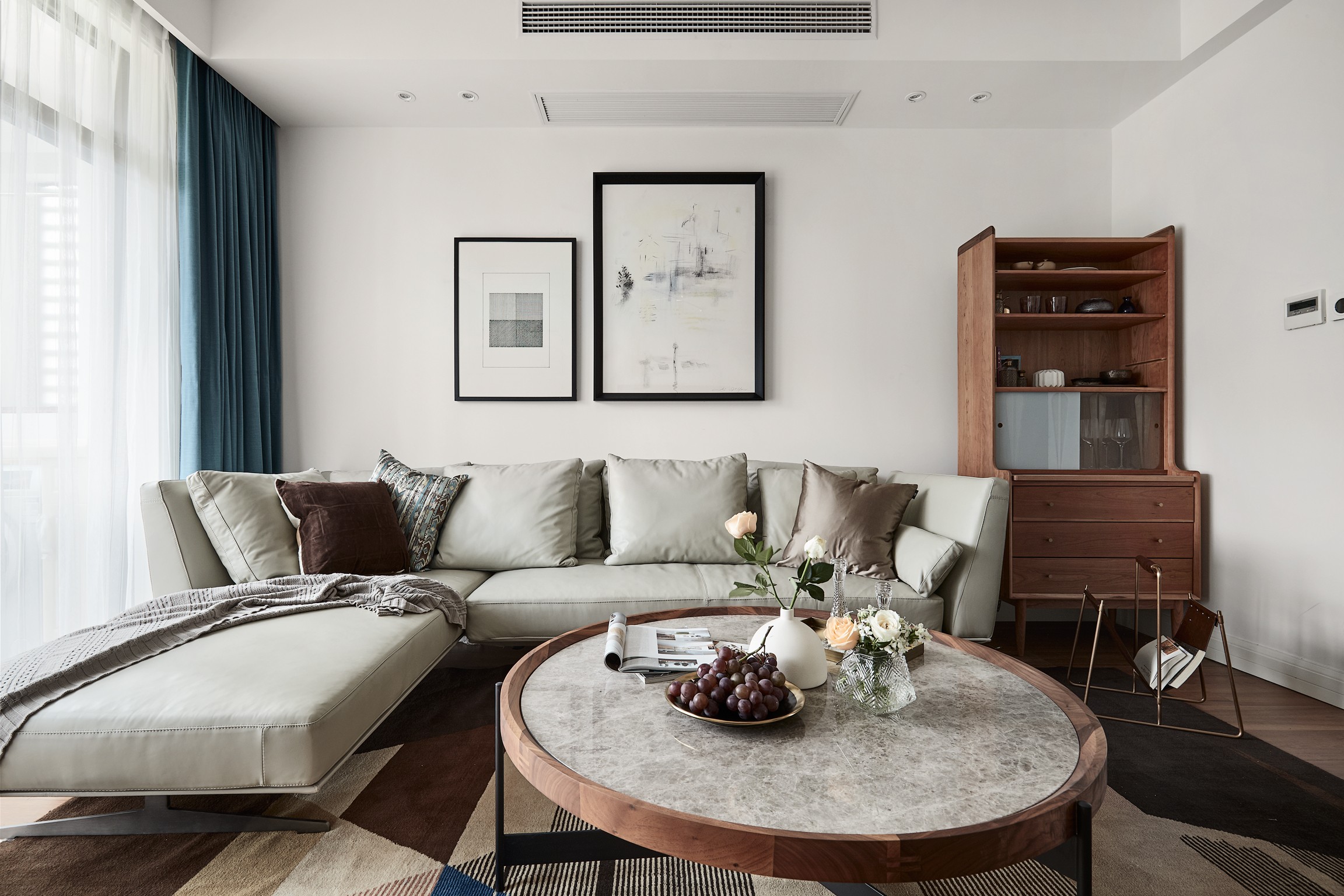 客厅整体设计带来清爽明快之意，皮质沙发搭配金色背景墙，温馨色感令人十分舒畅。