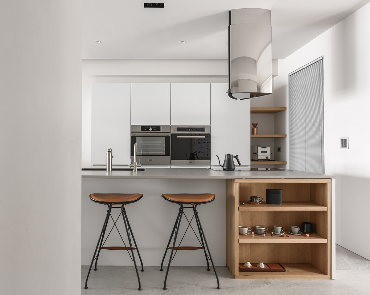 厨房以白色为主，局部嵌入小型电器，提升视觉装饰感，吧台设计增加空间灵活度。