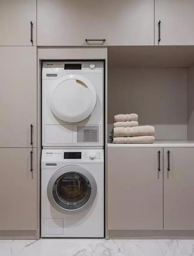 洗衣房无主灯设计，洗衣机内嵌柜面，让空间显得更加清爽，粉色吊柜更加高级情趣。