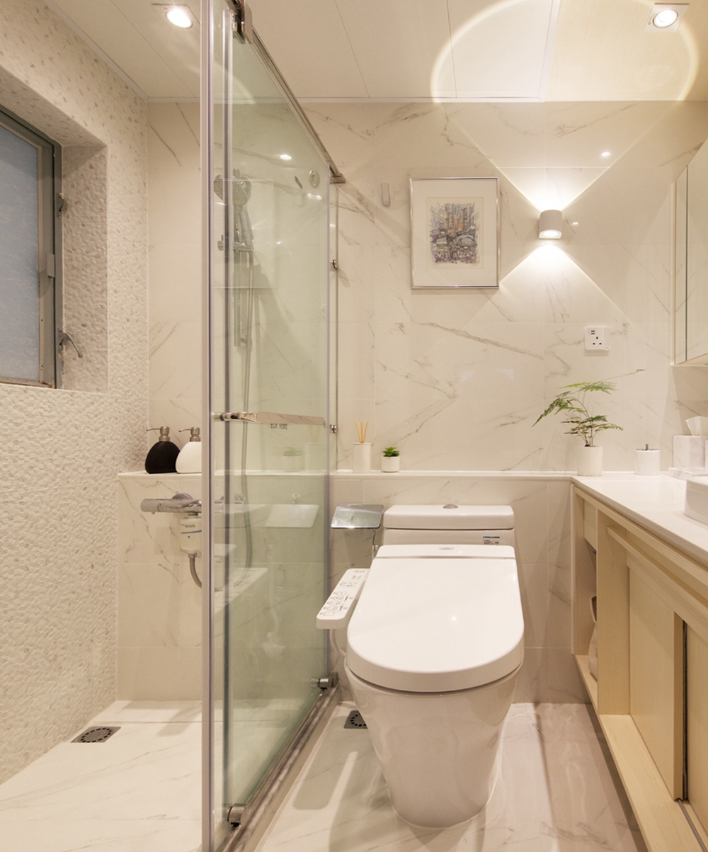 卫生间采用白色大理石铺装，再配以木色装饰增加空间的跳跃感，使空间精致感十足。