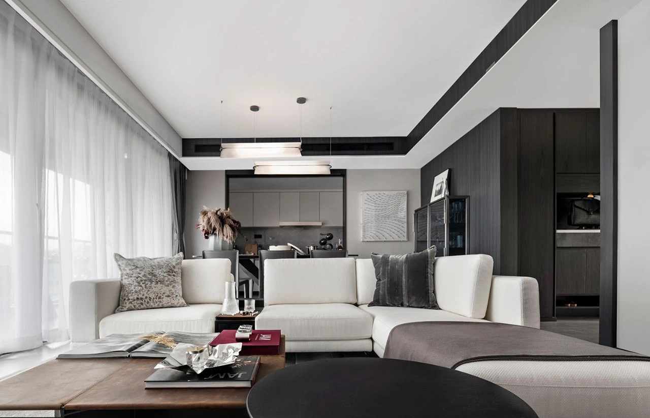 客厅以黑白咖为主题，白色沙发成为空间隔断，营造出一个素朴雅致的空间氛围。