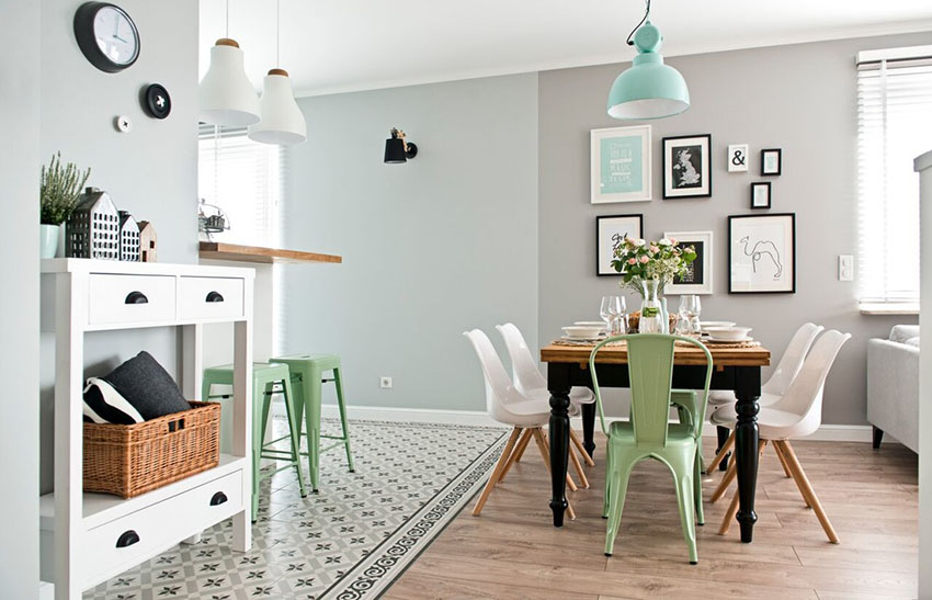 墙面以灰色和浅蓝色拼接，搭配木质餐桌和白色餐椅，餐饮氛围令人安怡。