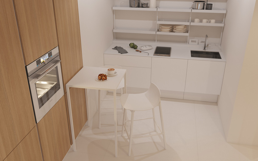 白色厨房中的简单的桌子和凳子是啜饮咖啡或阅读晨报的理想场所。
